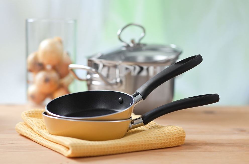 two yellow cooking pan and a pot