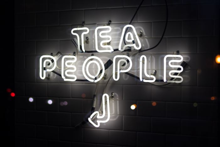 neon sign saying tea people