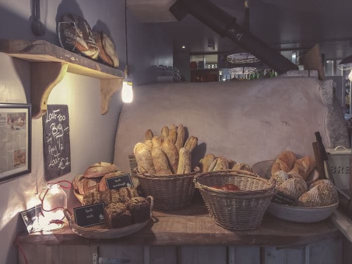 bakery counter with several kinds of artisan breads