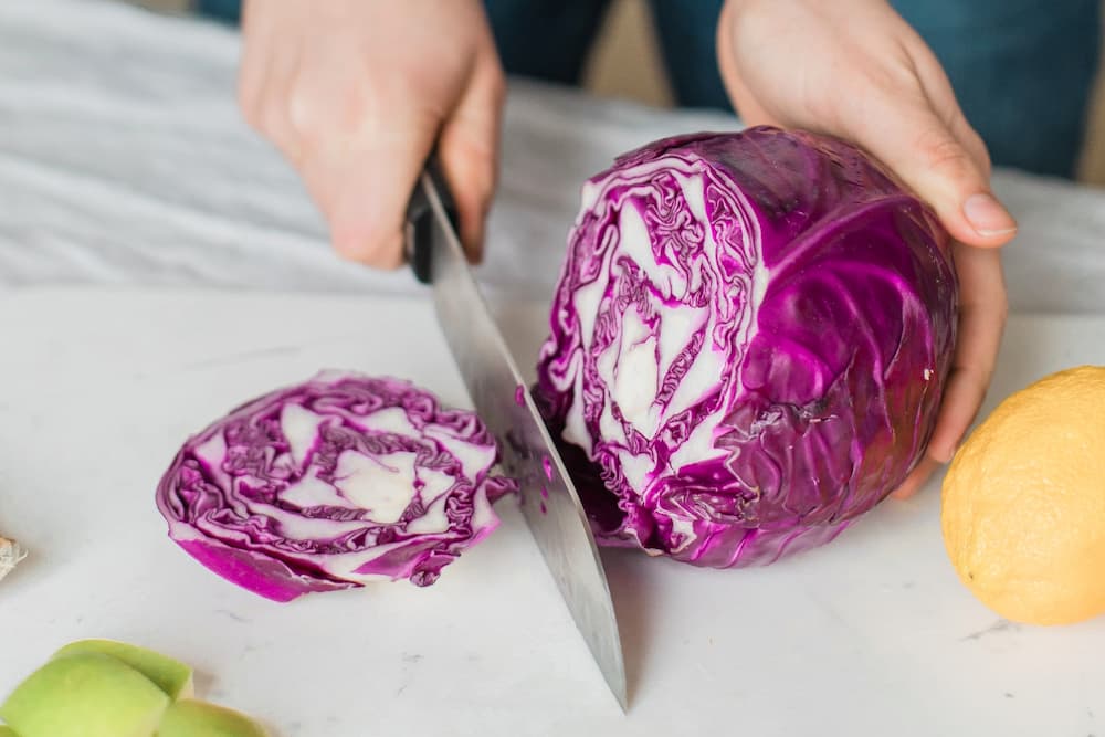 woman cutting cabbage for making juice